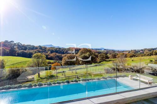 an image of a swimming pool in a house at Easy Clés-Luxury Villa 16p breathtaking view in Guéthary