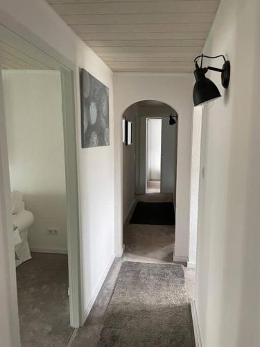 a hallway with a hallway leading to a room with a mirror at Haus am Grimnitzsee mit Garten in Joachimsthal