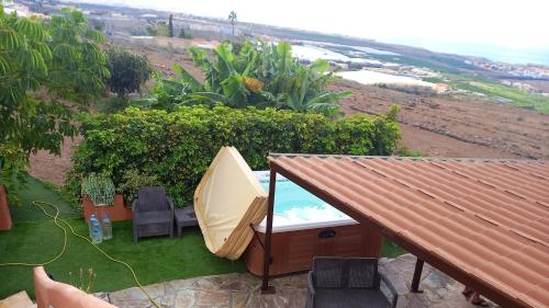 a hot tub with a table and chairs on a lawn at House with view and jacuzzi in Adeje in Adeje