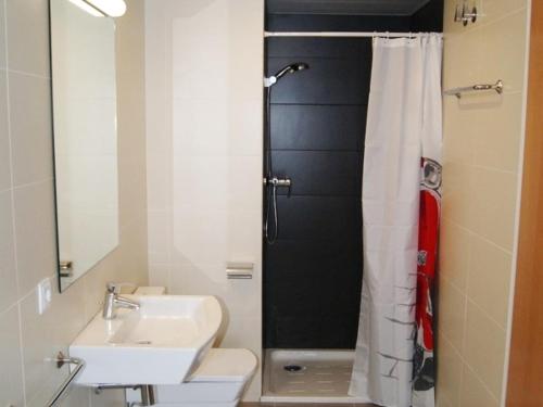 a bathroom with a toilet and a sink and a shower at Urpa Apartaments in Llança