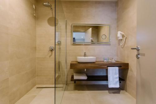 a bathroom with a sink and a shower at Hotel Buna Mostar in Buna