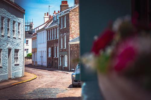 a view of a street with a car parked on the road at Blonde Hedgehog in Alderney
