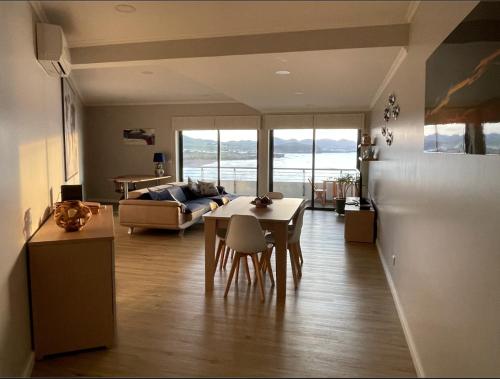 a living room with a table and a couch at Azorean Sunset Loft 2 in Ribeira Grande