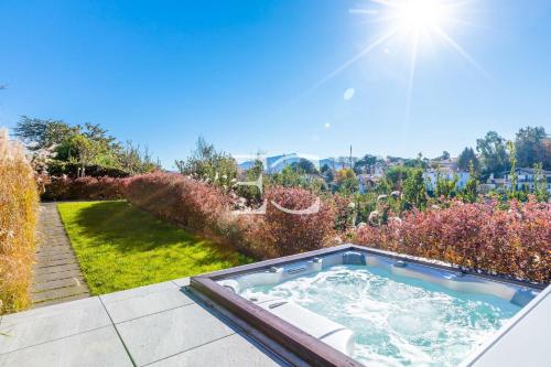 a hot tub in the backyard of a house at Easy Clés - Villa Jacuzzi Pool AC in Saint-Jean-de-Luz