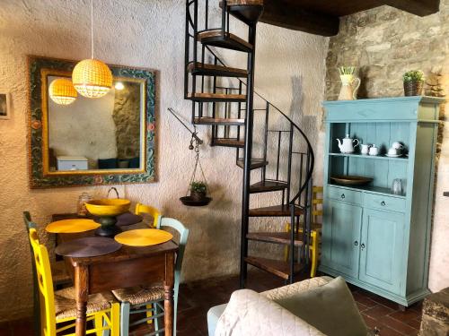 a dining room with a spiral staircase and a table at Locanda Angelica in Giarratana