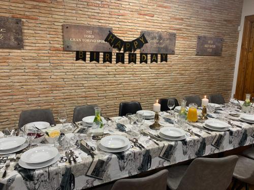 a long table with plates and glasses on it at Jantarvia Car Museum , Pasja i Wypoczynek Noclegi z Klimatem in Jantar