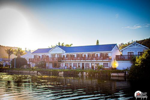 a large building next to a body of water at On The Estuary in Knysna