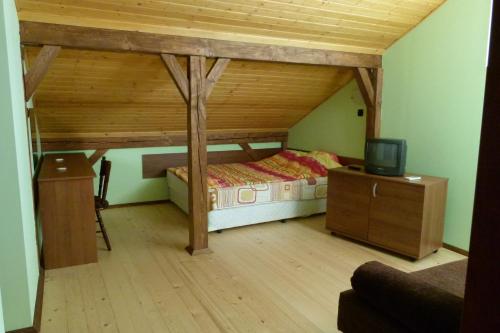 a bedroom with a bed and a tv in a room at Hotel Grivitsa in Pleven
