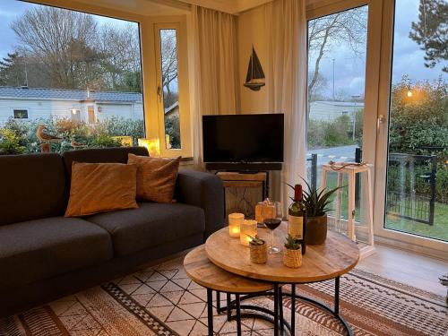 a living room with a couch and a table at Vakantiepark Kijkduin - 884 in The Hague