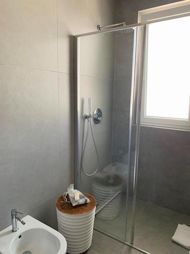 a bathroom with a shower and a sink and a toilet at Casa del Faro in Torre Canne
