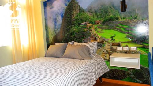 a bedroom with a wall mural of a resort at Terra Suites Ecogreen in Tacna