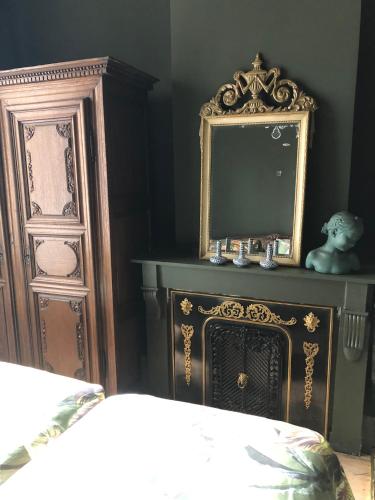 a bedroom with a mirror on top of a dresser at Sint Andries Suites in Antwerp