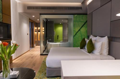 a hotel room with a bed and a bathroom at Al Khoory Courtyard Hotel in Dubai