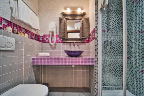 a bathroom with a sink and a mirror at Mas De Calabrun in Saintes-Maries-de-la-Mer