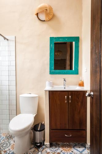 a bathroom with a toilet and a sink and a mirror at ANNAPURNA Villa de Leyva in Villa de Leyva