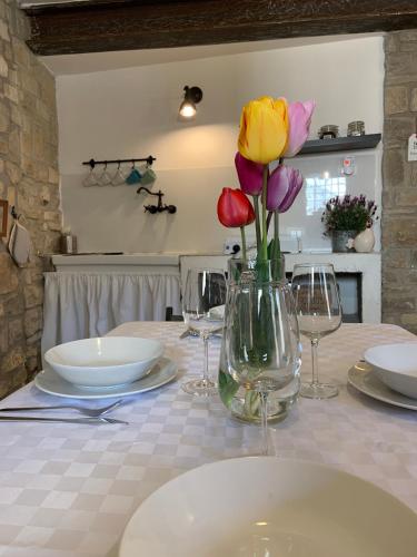 a table with flowers in a vase on it at Da Agostino, la casa del latte in Costa di Mezzate
