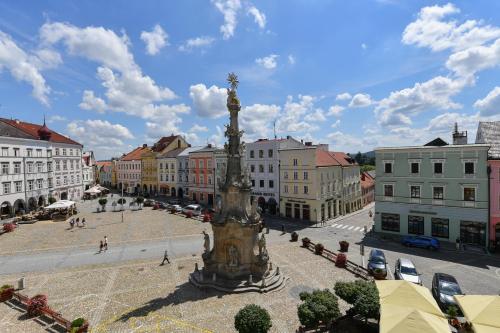 a large statue in the middle of a city at Apartmány Na Náměstí 85 in Jindrichuv Hradec