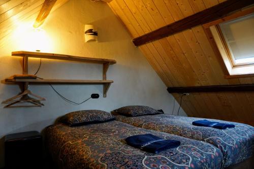 a bedroom with a bed with blue pillows on it at Hostel Kersenhof in Uden
