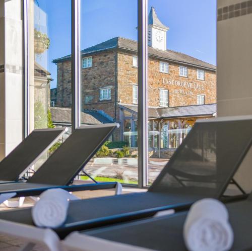 a row of treadmills in front of a window at Last Drop Village Hotel & Spa in Bolton