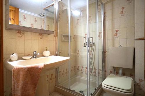 a bathroom with a shower and a sink and a toilet at Villa Vasiliki in Paralía Avdhíron