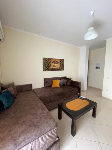 a living room with a couch and a table at Relax Apts Saranda in Sarandë