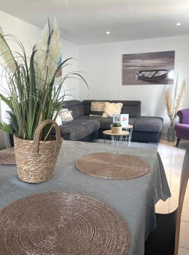 a living room with a table with plants on it at La Maison Blanche in Sangatte