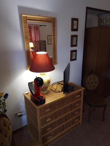 a desk with a lamp and a computer on it at L'Antica Quercia B&B in CastellʼUmberto
