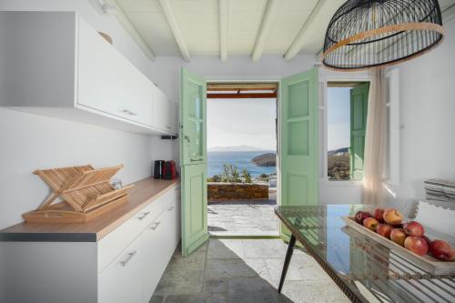 a kitchen with a table and a view of the ocean at SERIFOS BELLA VISTA 1 in Livadi