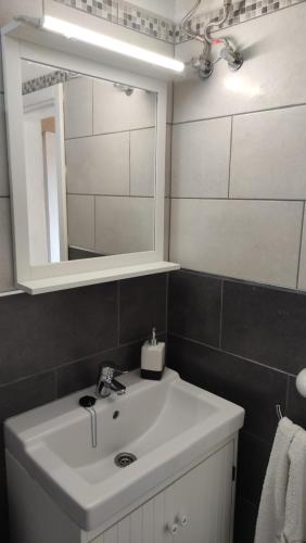 a bathroom with a white sink and a mirror at CASA MÉRIDA in Echedo