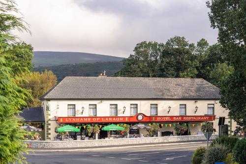 a white building on the side of a road at Lynhams Hotel in Laragh