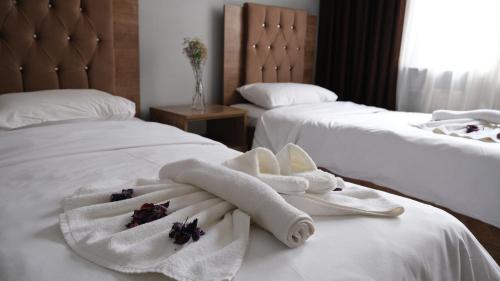 a hotel room with two beds with towels on them at BIG MOLLS HOTEL in Istanbul
