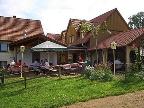 a group of people sitting at a table outside of a building at Daumsmuhle in Mossautal