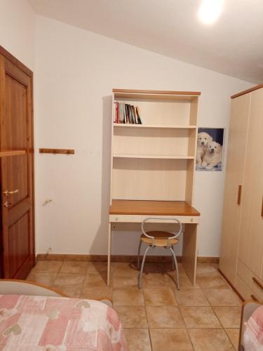 a bedroom with a desk and a chair at VILLA LUPINO in Orosei