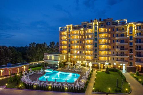 a large building with a large pool of water in front of it at Landmark Creek Hotel & Wellness in Plovdiv