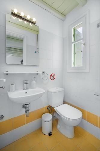 a bathroom with a toilet and a sink and a mirror at SERIFOS BELLA VISTA 1 in Livadi