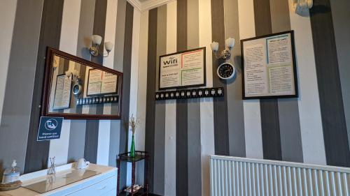 a room with stripes on the wall with a sink at Areawest in Scarborough