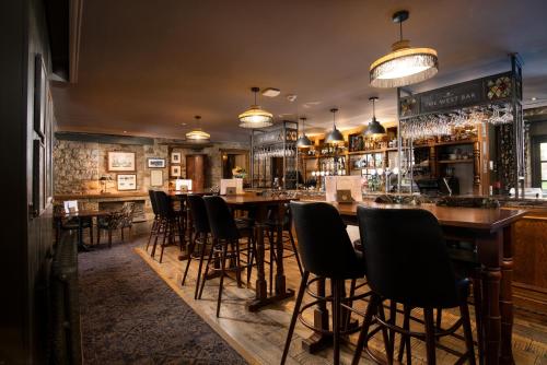 a bar with chairs and tables in a restaurant at The Black Swan - The Inn Collection Group in Helmsley