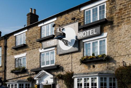 a hotel sign on the side of a building at The Black Swan - The Inn Collection Group in Helmsley