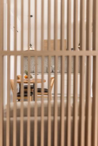 a table and chair in a room with white walls at PORTO SERENO apartments in Šibenik