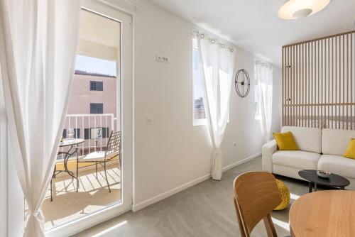 a living room with a couch and a table at PORTO SERENO apartments in Šibenik