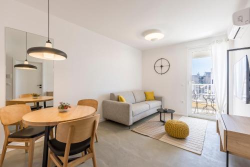 a living room with a table and a couch at PORTO SERENO apartments in Šibenik