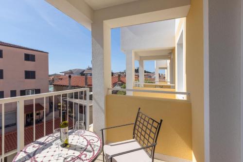 a balcony with a table and chairs on a balcony at PORTO SERENO apartments in Šibenik