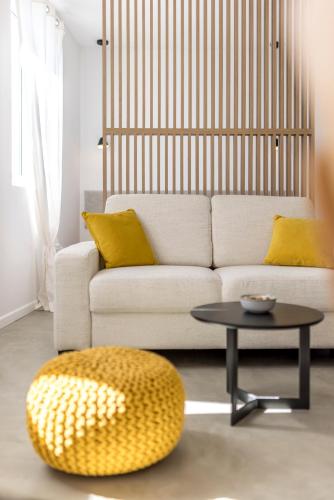 a living room with a white couch and a table at PORTO SERENO apartments in Šibenik