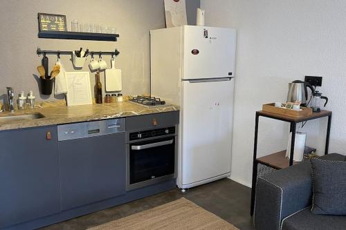 a kitchen with a white refrigerator and a stove at K Studio in Bodrum City