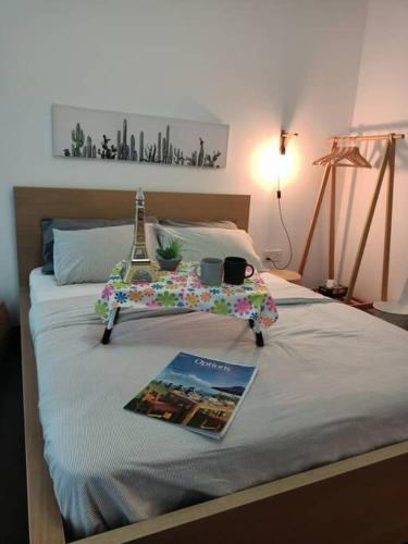 a bed with a magazine on it with the eiffel tower on it at MUJI STYLE STUDIO Almas 100mbps Pool View Netflix By STAY in Nusajaya