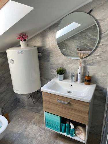 a bathroom with a sink and a mirror at Apartment Atina in Kotor