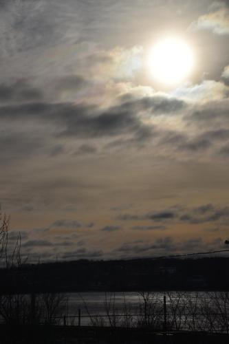 a sun setting over a body of water at Seabank House Bed and Breakfast Hummingbird in Pictou