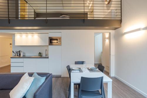 a kitchen and a living room with a table and chairs at Suite Brunate - by MyHomeInComo in Como