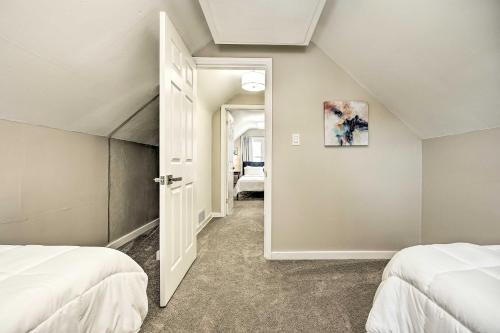 a bedroom with two beds and an open door at Modern South Bend Getaway about 3 Mi to Downtown in South Bend