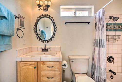 a bathroom with a sink and a toilet and a mirror at Romantic Treetop Studio 30 Mi to Yosemite! in Coarsegold